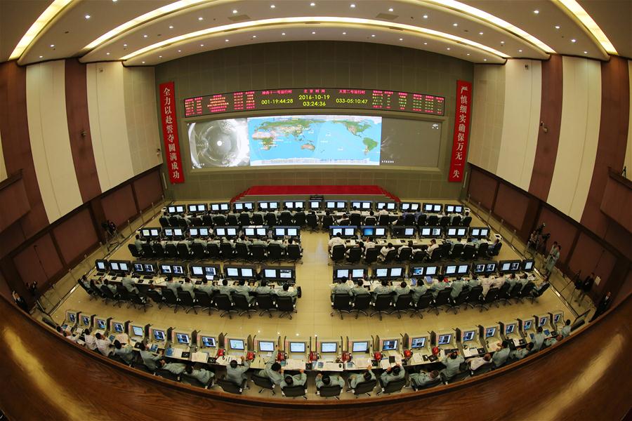 Photo taken on Oct. 19, 2016 shows the hall of the Beijing Aerospace Control Center. The Shenzhou-11 manned spacecraft successfully completed its automated docking with the orbiting Tiangong-2 space lab Wednesday morning, according to Beijing Aerospace Control Center. (Xinhua/Ju Zhenhua) 