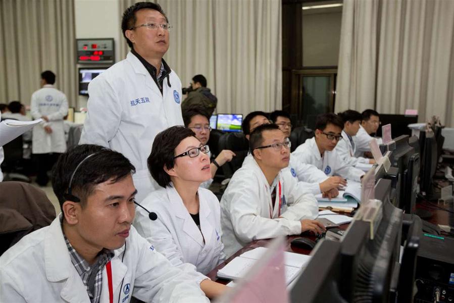 Staff members work before the Shenzhou-11 manned spacecraft&apos;s docking with the orbiting space lab Tiangong-2 at the Beijing Aerospace Control Center in Beijing, capital of China, Oct. 19, 2016. (Xinhua/Ju Zhenhua) 