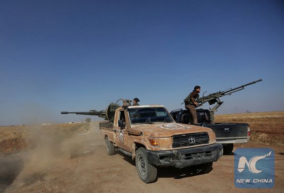 Rebel fighters in Marea city shoot a weapon towards Syria Democratic Forces (SDF) controlled Tell Rifaat town, northern Aleppo province, Syria, October 21, 2016. [Photo/Xinhua]