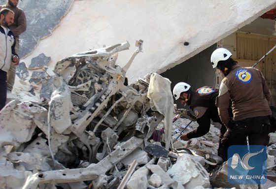 Rescuers inspect a destroyed building in the Syrian village of Kfar Jales, on the outskirts of Idlib, following air strikes by Syrian and Russian warplanes on November 16, 2016. [Photo/Xinhua]