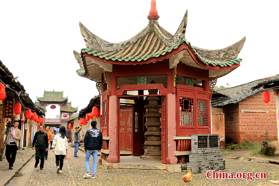 The photo shows Guifeita Pagoda located on the cobblestone lane of the Zhuji Ancient Lane. The stone pagoda was rebuilt in 1350 in Yuan Dynasty. It has seven stories and is compiled of 17 pieces of red carved-sandstone. It is 3.36 meters high. [Photo by Li Huiru / China.org.cn]
