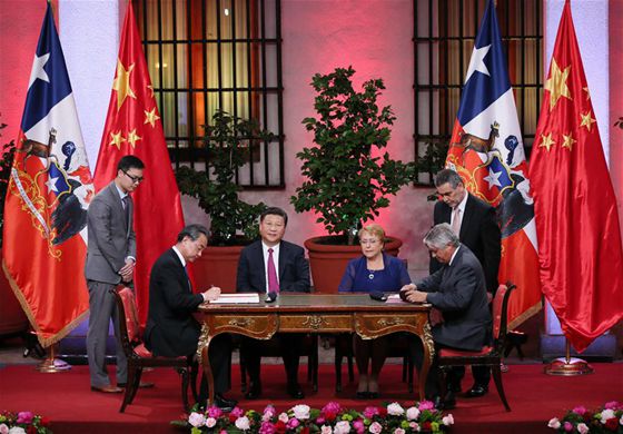 Chinese President Xi Jinping (3rd L) and Chilean President Michelle Bachelet (3rd R) witness the signing of cooperation agreements on trade and economy, agriculture, quality control, culture, education, e-commerce, information communication and finance, after their talks in Santiago, capital of Chile, Nov. 22, 2016. [Photo/Xinhua]