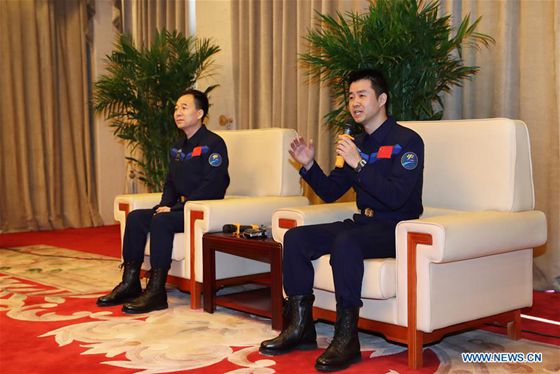 Chinese astronaut Chen Dong (R) answers questions during a press conference in Beijing, capital of China, Dec. 7, 2016. [Photo/Xinhua]