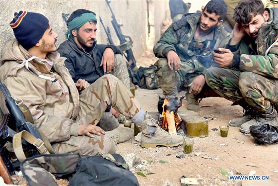 Soldiers of pro-government militia rest in Aleppo, Syria, on Dec. 11, 2016. [Photo/Xinhua]