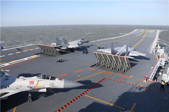 Carrier-based J-15 fighters prepare to take off from aircraft carrier Liaoning in a drill in the Bohai Sea. [Photo/China Daily] 