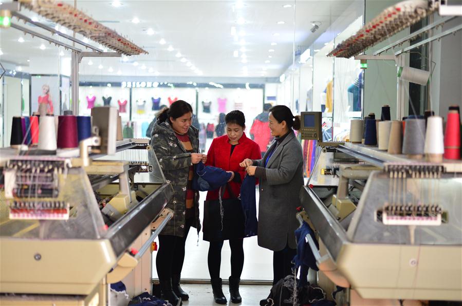 Customers shop for cashmere products at the 23rd China Qinghe International Cashmere and Fluff Products Fair in Qinghe County, north China's Hebei Province, Dec. 16, 2016. The 3 days fair, attracting more than 2,000 traders at home and abroad, opened on Friday in Qinghe, a traditional textile base. (Xinhua/Chen Lei) 