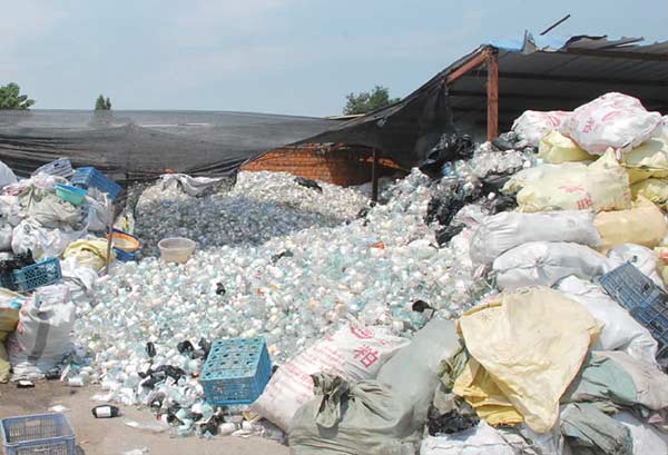 Large piles of medical waste sit at a dump site near Gujia village in Nanjing. [Photo/China Daily]