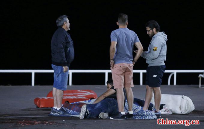 An injured individual is seen on the ground after 85 people were killed in Nice, France, when a truck ran into a crowd celebrating the Bastille Day national holiday July 14, 2016. [Photo/China.org.cn]