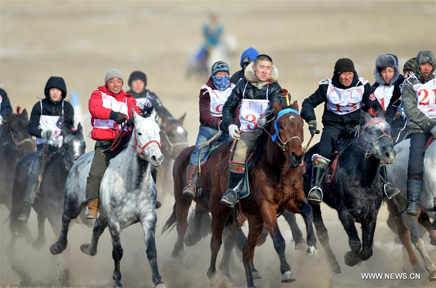 Mongolian herdsmen attend a horse racing match at a winter Nadam fair in West Ujimqin Banner, north China&apos;s Inner Mongolia Autonomous Region, Jan. 7, 2017. The 5-day event kicked off here on Saturday. Nadam Fair, meaning &apos;entertainment&apos; or &apos;recreation&apos; in Mongolian, is a mass traditional Mongolian festival mainly filled with sports events.(Xinhua/Ren Junchuan) 