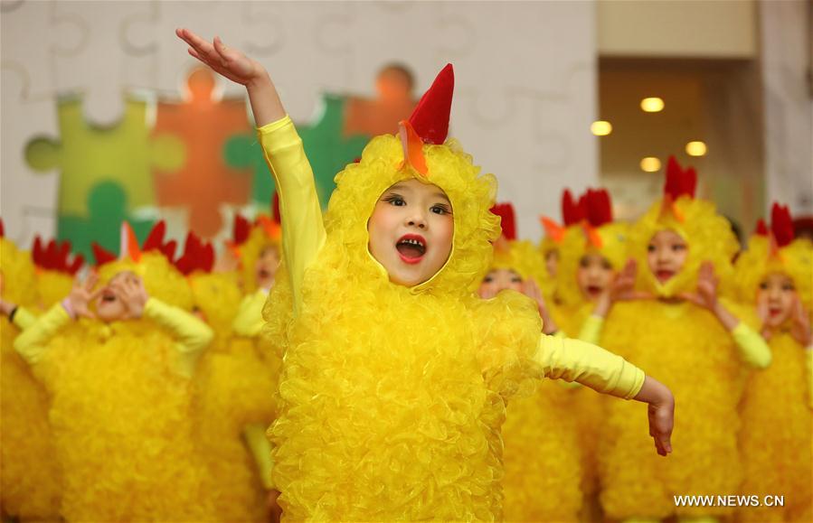 Children wearing chicken costumes dance at a temple fair event for the upcoming Spring Festival in Tianjin, north China, Jan. 7, 2017. The Spring Festival falls on Jan. 28 this year. (Xinhua/Liu Dongyue) 
