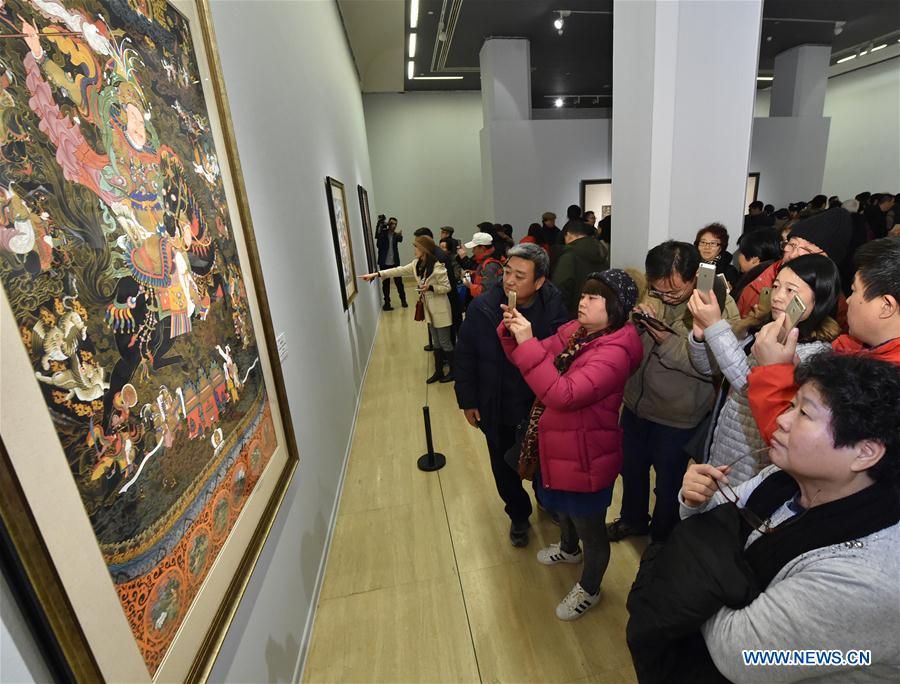 People visit an exhibition of Tibetan Thangka painting in Beijing, capital of China, Jan. 7, 2017. (Xinhua/Li He) 