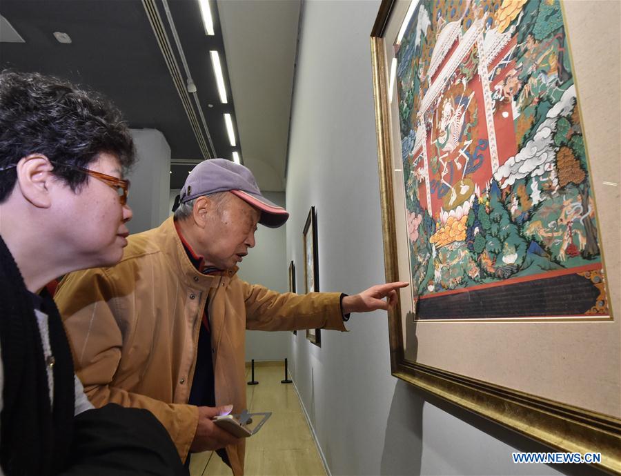 People visit an exhibition of Tibetan Thangka painting in Beijing, capital of China, Jan. 7, 2017. (Xinhua/Li He)