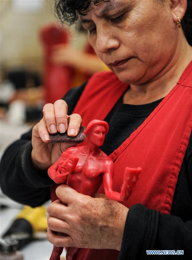 A worker polishes a wax mold of statuette of 'The Actor' for the 23rd annual Screen Actors Guild (SAG) Awards in Burbank, California, the United States, on Jan 17, 2017. 