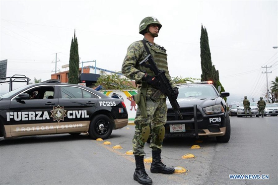 A security member stands guard outside the American School of the Northeast where a shooting occurred in Monterrey, Nuevo Leon state, Mexico, on Jan. 18, 2017. [Photo/Xinhua]