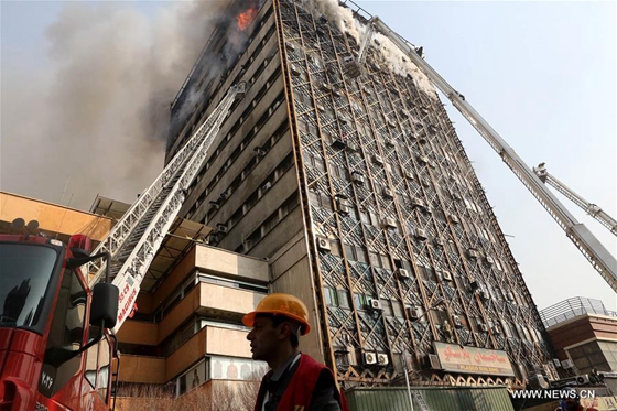Iranian firefighters work on a commercial building in downtown Tehran, Iran, on Jan. 19, 2017. [Photo/Xinhua]