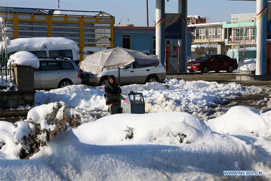 An Afghan vendor waits for costumers after a heavy snow in eastern Ghazni province, Afghanistan, Feb. 6, 2017. At least 100 people have lost their lives and more than 50 others sustained injuries due to snowfall and freezing weather over the past few days across Afghanistan, local media reported. (Xinhua/Sayed Mominzadah)