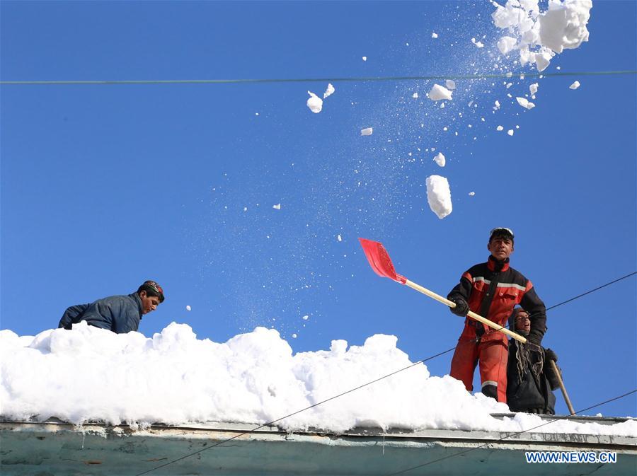 People clean the snow in eastern Ghazni province, Afghanistan, Feb. 6, 2017. At least 100 people have lost their lives and more than 50 others sustained injuries due to snowfall and freezing weather over the past few days across Afghanistan, local media reported. (Xinhua/Sayed Mominzadah) 