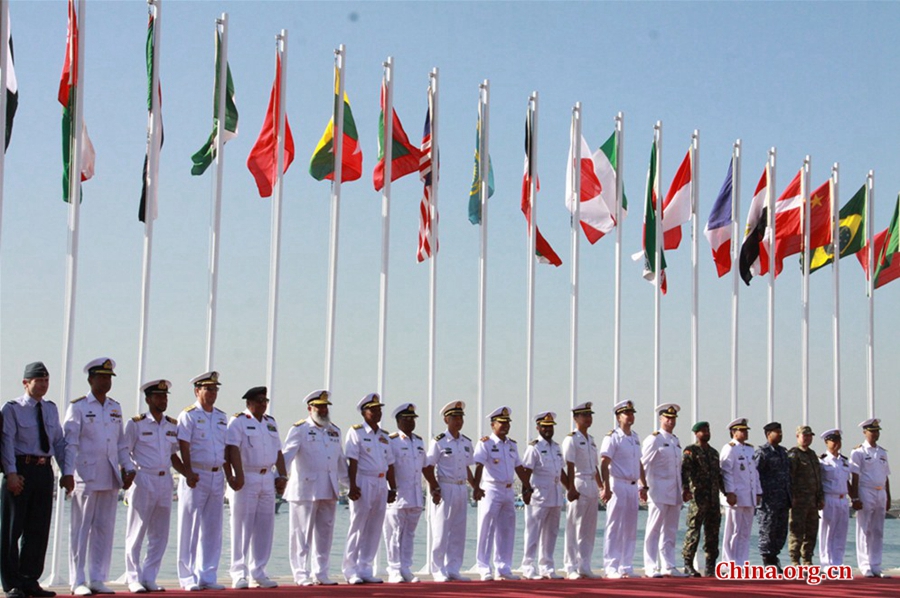 Senior naval officials take a photo in front of their national flags at the opening ceremony of multinational naval exercise AMAN-17 at Pakistan Navy Dockyard in Karachi on Feb. 10, 2017. [China.org.cn / by Guo Xiaohong]