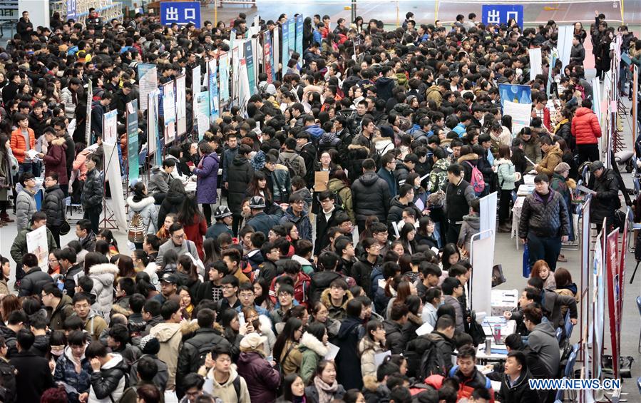 Graduates seek job opportunities during a job fair in Tianjin, north China, Feb. 10, 2017. Job fairs are held across China after the Spring Festival holiday. [Photo/Xinhua]