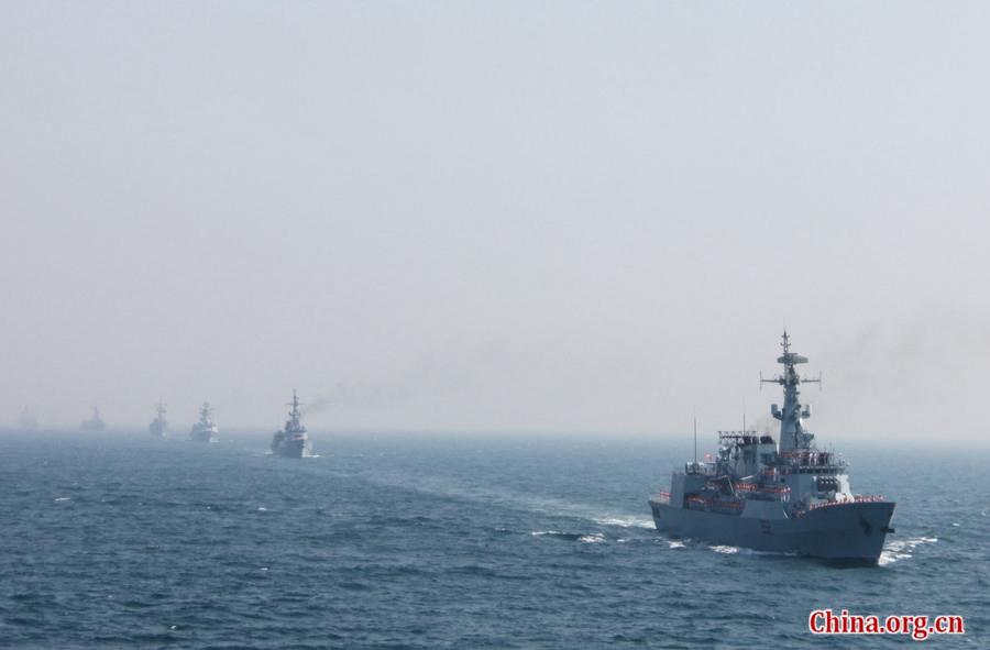 Seventeen ships representing their respective countries pass by Pak Navy comprehensive supply ship PNS NASR, the flagship of AMAN-17 exercise. The AMAN-17 multinational naval exercise concludes with a spectacular exercise in the North Arabian Sea off Pakistan on Feb. 14, 2017.. [Photo by Guo Xiaohong/China.org.cn] 