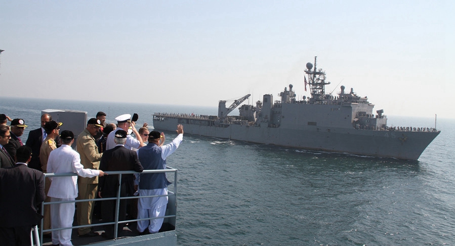 Pakistan PM Nawaz Sharif and other dignitaries wave while a foreign ship pays its respects to the premier on the concluding day of Exercise AMAN-17 on Feb. 14, 2017. [Photo courtesy of Pak Navy]