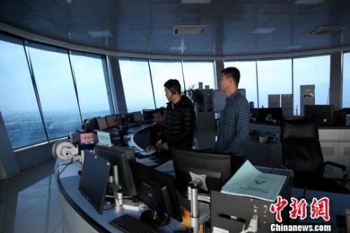 Two air traffic controllers working inside an air traffic control tower.[Photo: Chinanews.com]