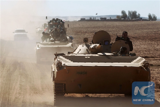 Iraqi forces's BMP-1 infantry fighting vehicles, supported by the Hashed al-Shaabi (Popular Mobilisation) paramilitaries, advance towards the village of Sheikh Younis, south of Mosul, after the offensive to retake the western side of the city from Islamic State (IS) group fighters commenced on February 19, 2017. [Photo/Xinhua]