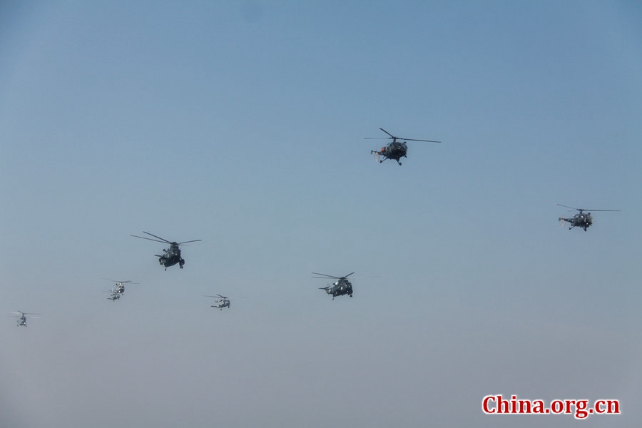 Helicopters from Pakistan, China, Russia, and Turkey performing a fly-past. The AMAN-17 multinational naval exercise concludes with a spectacular exercise in the North Arabian Sea off Pakistan on Feb. 14, 2017. [Photo by Guo Xiaohong/China.org.cn]