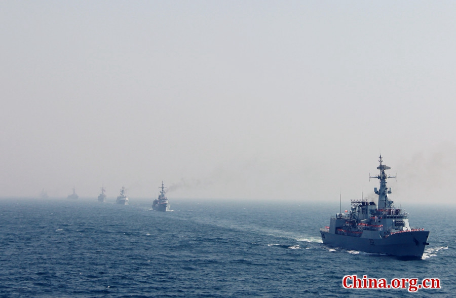 Seventeen ships representing their respective countries pass by Pak Navy comprehensive supply ship PNS NASR, the flagship of AMAN-17 exercise. The AMAN-17 multinational naval exercise concludes with a spectacular exercise in the North Arabian Sea off Pakistan on Feb. 14, 2017. [Photo by Guo Xiaohong/China.org.cn]