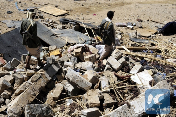 A man stands on rubble of a funeral house that was hit in airstrike in Arhab district, about 40 km north of Sanaa, capital of Yemen, on Feb. 16, 2017. [Photo/Xinhua]