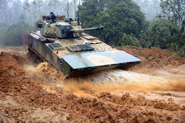 A ZBD-05 amphibious infantry fighting vehicle (IFV) wades through the mud puddle during a round-the-clock driving skills training exercise at a military training base in southeast China's Fujian Province on February 24, 2017. (81.cn/ He Sheng)