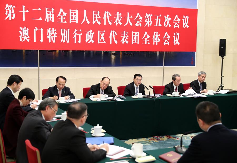 Zhang Dejiang, chairman of the Standing Committee of China's National People's Congress (NPC), joins a panel discussion with deputies to the 12th NPC from Macao Special Administrative Region at the annual session of the NPC in Beijing, capital of China, March 6, 2017. (Xinhua/Xie Huanchi)