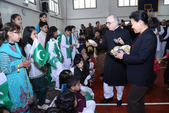 Ambassador with the children who sang the national songs at the event.
