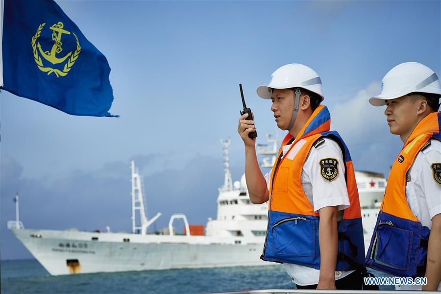 Staff members of Sanya Maritime Safety Administration check the anchorage of 'Xiangyanghong 09', carrier of China's manned deep-sea submersible Jiaolong, in Sanya, south China's Hainan Province, April 8, 2017. The crew of China's 38th ocean scientific expedition returned to Sanya, Hainan Province, south China, Wednesday. The 59-day trip marks the conclusion of the first stage of a 124-day mission. [Photo/Xinhua]