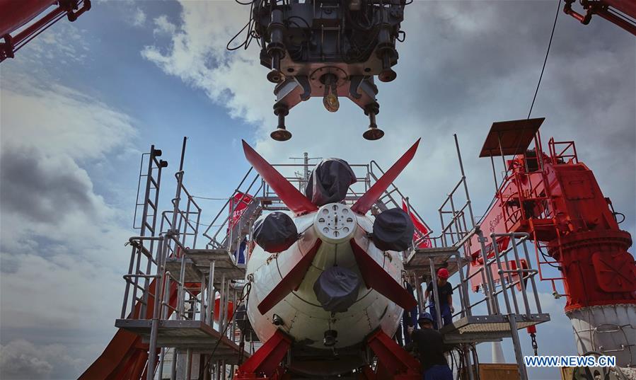 Crew members check China's manned deep-sea submersible Jiaolong in Sanya, south China's Hainan Province, April 8, 2017. The crew of China's 38th ocean scientific expedition returned to Sanya, Hainan Province, south China, Wednesday. The 59-day trip marks the conclusion of the first stage of a 124-day mission. [Photo/Xinhua] 