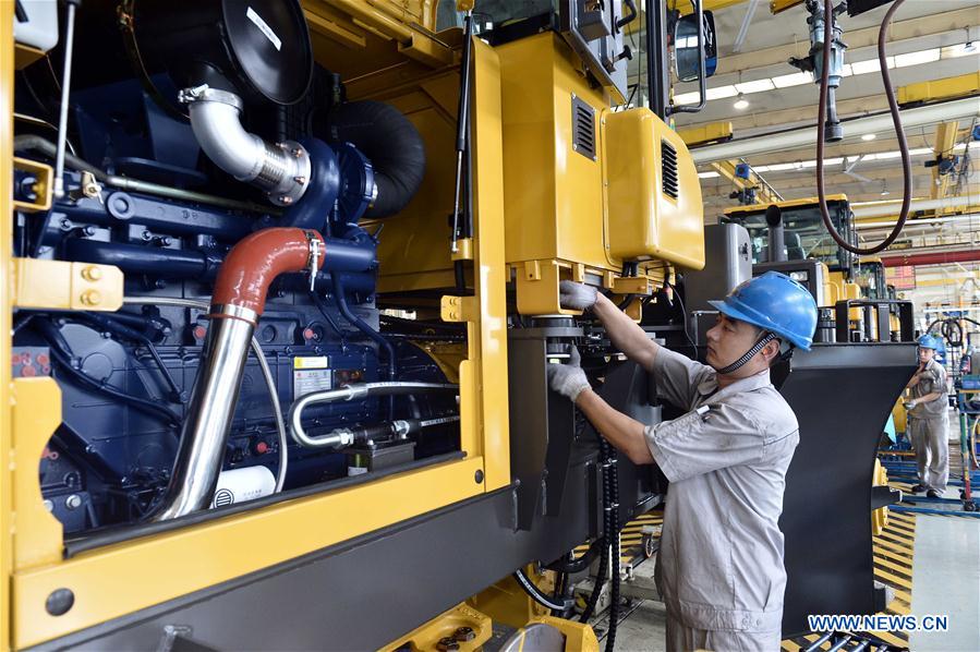 A worker is seen on the assembly line of loading machine in Shandong Lingong Construction Machinery Co., Ltd. in Linyi, east China&apos;s Shandong Province, May 4, 2017. The enterprise have exported its construction machinery products to Malaysia, India, Russia, Saudi Arabia and some other countries and regions. (Xinhua/Guo Xuelei)