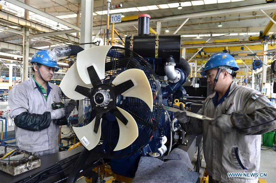 Workers are seen on the assembly line of loading machine in Shandong Lingong Construction Machinery Co., Ltd. in Linyi, east China&apos;s Shandong Province, May 4, 2017. The enterprise have exported its construction machinery products to Malaysia, India, Russia, Saudi Arabia and some other countries and regions. (Xinhua/Guo Xuelei)