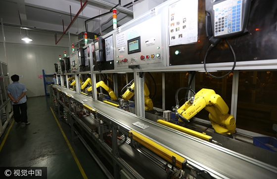 An automated assembly line with robotic hands in Dongguan, Guangdong Province. [Photo/VCG]