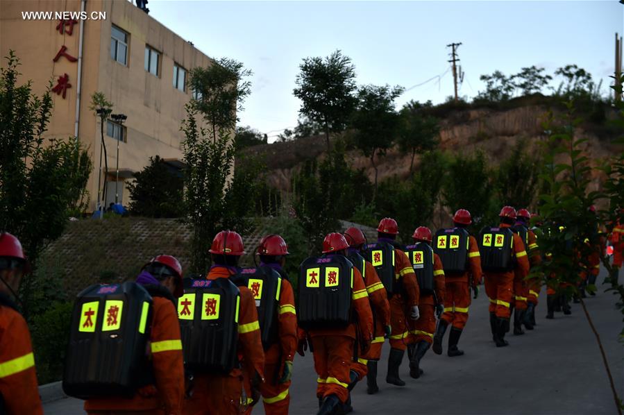 Rescuers walk to the scene of the flooded coal mine in Qingxu County, north China&apos;s Shanxi Province, May 23, 2017. Four of 11 trapped miners have been rescued following a coal mine flood late Monday night in Shanxi Province, according to the rescue headquarters late Tuesday. Rescuers are still searching for the other seven trapped miners. (Xinhua/Cao Yang)