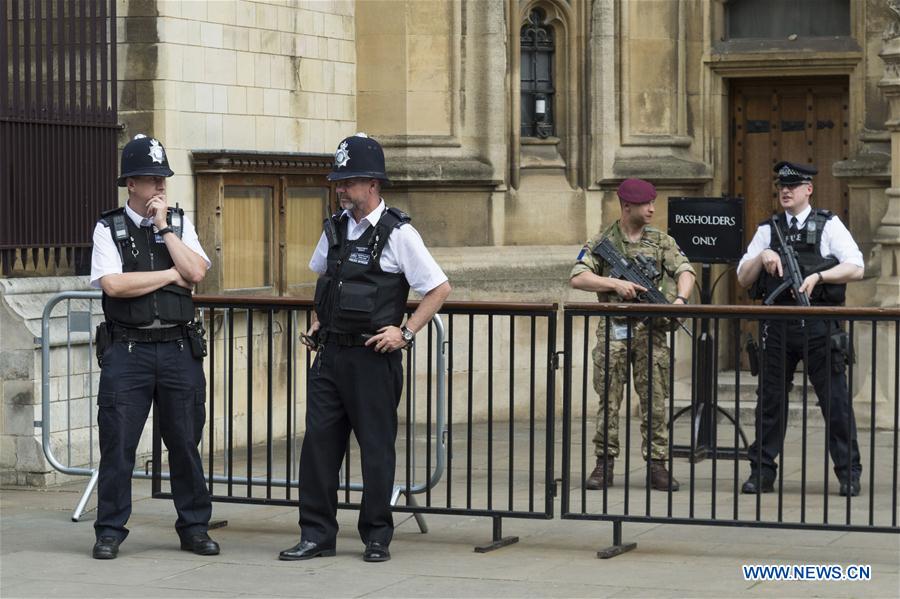 An armed soldier and armed police officers stand guard outside the Houses of Parliament in London, Britain, on May 24, 2017. British Prime Minister Theresa May announced Tuesday night that the country&apos;s terror threat level has been raised from &apos;severe&apos; to &apos;critical&apos;, its highest level. (Xinhua/Ray Tang) 