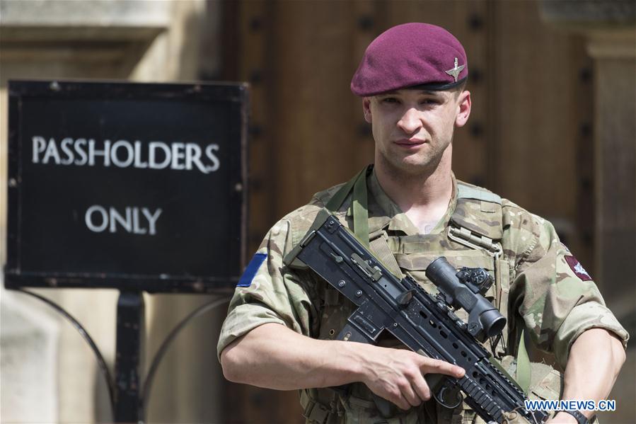 An armed soldier stands guard outside the Houses of Parliament in London, Britain, on May 24, 2017. British Prime Minister Theresa May announced Tuesday night that the country&apos;s terror threat level has been raised from &apos;severe&apos; to &apos;critical&apos;, its highest level. (Xinhua/Ray Tang) 