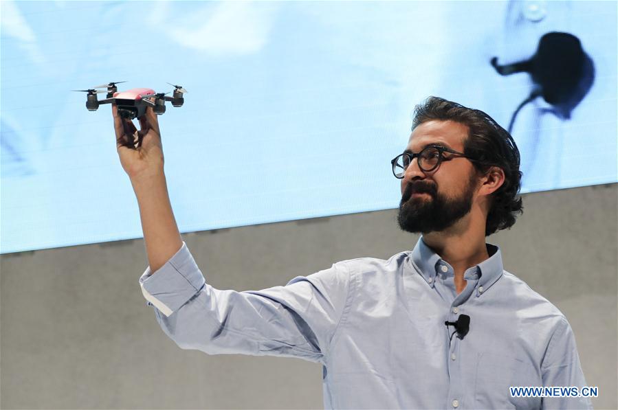 Michael Perry, director of strategic partnerships of DJI, demonstrates the palm-sized drone &apos;Spark&apos; during an event in New York, the United States, on May 24, 2017. DJI announced its first palm-sized drone &apos;Spark&apos; here on Wednesday. (Xinhua/Wang Ying)