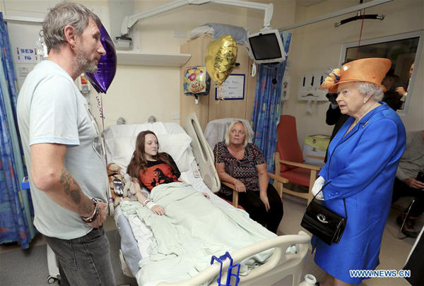 Queen Elizabeth II (R) visits the Royal Manchester Children's Hospital to meet victims of the Manchester Arena attack, in Manchester, Britain, May 25, 2017. (Xinhua)