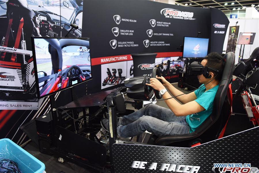 A visitor tries a race driving simulator at the Hong Kong International Auto Show 2017 in Hong Kong Convention and Exhibition Center in Hong Kong, south China, May 26, 2017. The 3-day auto show started on Friday. (Xinhua/Qin Qing)