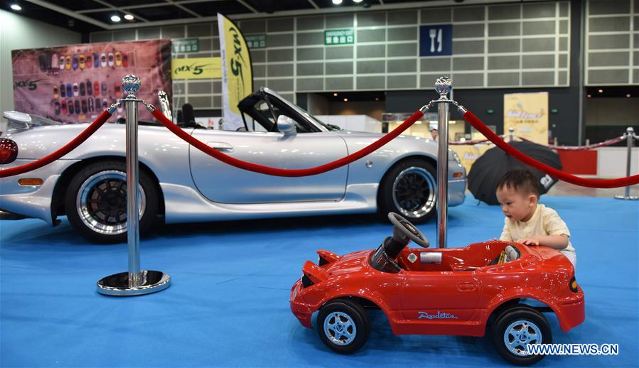A child watches a toy car at the Hong Kong International Auto Show 2017 in Hong Kong Convention and Exhibition Center in Hong Kong, south China, May 26, 2017. The 3-day auto show started on Friday. (Xinhua/Qin Qing)