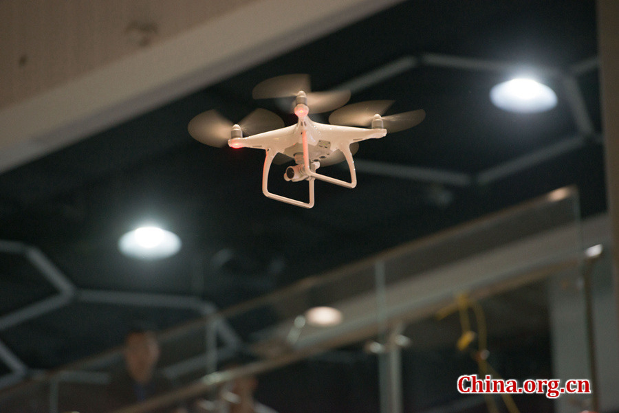 Children and adults enjoy a show of quadrocopter formation flight during a grand celebration held at the newly established China Soong Ching Ling Science and Culture Center for Young People in Beijing on May 31, one day ahead of International Children's Day. [Photo by Chen Boyuan / China.org.cn]