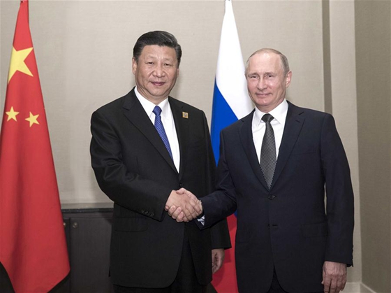 Chinese President Xi Jinping (L) meets with Russian President Vladimir Putin in Astana, Kazakhstan, June 8, 2017. [Photo/Xinhua]