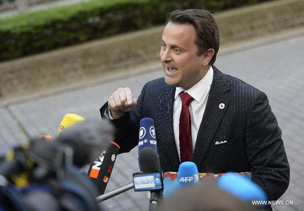 Luxembourg Prime Minister Xavier Bettel speaks to media upon his arrivals at EU-Ukraine head of states Summit at the EU headquarters in Brussels, capital of Belgium, March 6, 2014. (Xinhua/Ye Pingfan)