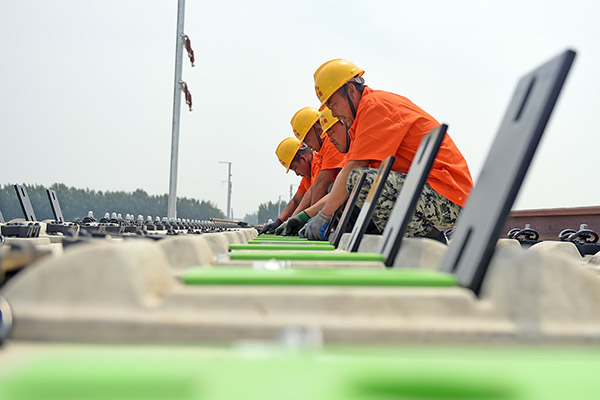 Technicians work at the Liaoning section of a high-speed railway in Northeast China's Liaoning province, June 17, 2017. [Photo/Xinhua] 