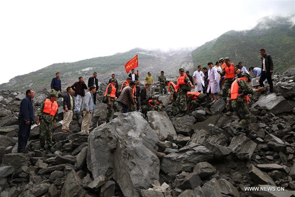 Rescuers work at the accident site after a landslide occurred in Xinmo Village of Maoxian County, Tibetan and Qiang Autonomous Prefecture, southwest China's Sichuan Province, June 24, 2017. The landslide on Saturday morning smashed 46 homes, and 141 people are missing. [Photo/Xinhua]